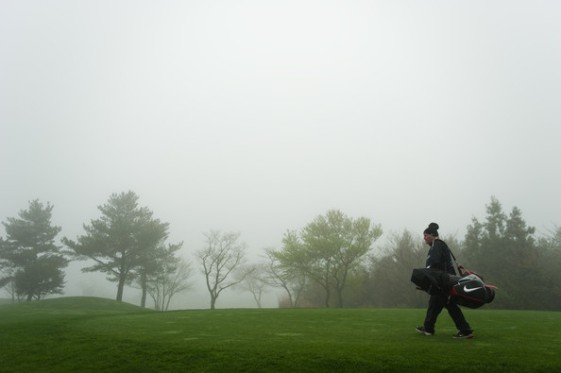 El caddie de Richard Finch camina bajo la espesa niebla de Corea durante la primera ronda.