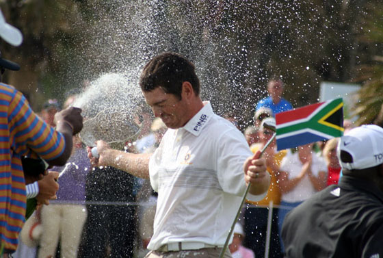 Louis Oosthuizen es bañado en champán por caddies y jugadores sudafricanos tras ganar en el Parador.