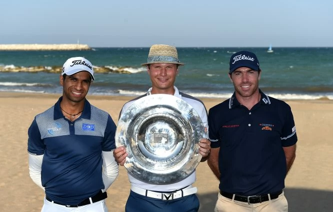 Aaron Rai of England, Tapio Pulkkanen of Finland and Julien Guerrier of France pose with the trophy prior to the NBO Golf Classic Grand Final - European Challenge Tour at Al Mouj Golf on October 30, 2017 in Muscat, Oman. (Photo by Tom Dulat/Getty Images)