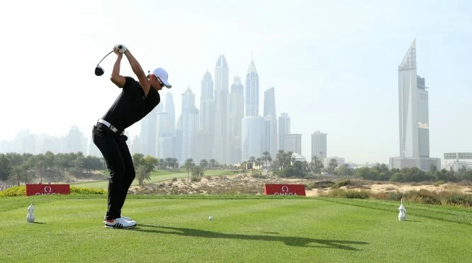 Haotong Li of China tees off on the 8th hole with the city as a backdrop during day three of Omega Dubai Desert Classic at Emirates Golf Club on January 27, 2018 in Dubai, United Arab Emirates. (Photo by Andrew Redington/Getty Images)