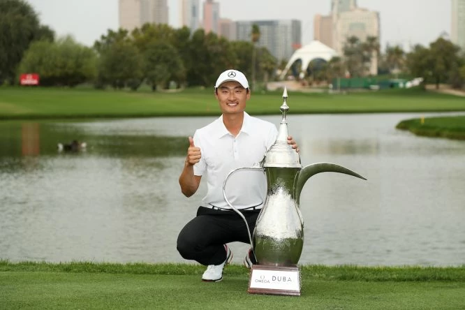 Haotong Li posa con el trofeo de ganador del Omega Dubai Desert Classic. © Golffile | Fran Caffrey
