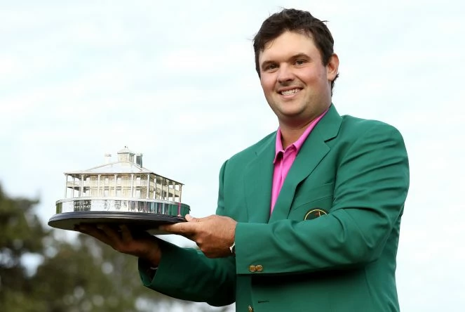 Patrick Reed of the United States celebrates with the trophy during the green jacket ceremony after winning the 2018 Masters Tournament at Augusta National Golf Club on April 8, 2018 in Augusta, Georgia. (Photo by Jamie Squire/Getty Images)