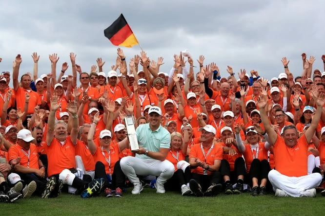Matt Wallace of England celebrates with the trophy and tournament volunteers after winning the BMW International Open at Golf Club Gut Larchenhof on June 24, 2018 in Cologne, Germany. (Photo by Matthew Lewis/Getty Images)