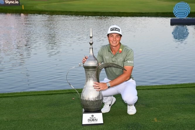 Viktor Hovland of Norway poses with the trophy after his victory in a playoff during day four of the Slync.io Dubai Desert Classic at Emirates Golf Club on January 30, 2022 in Dubai, United Arab Emirates. (Photo by Ross Kinnaird/Getty Images)