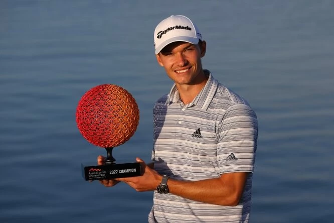 Nicolai Hojgaard of Denmark poses for a photo with the trophy after winning the Ras al Khaimah Championship during day four of the Ras al Khaimah Championship presented by Phoenix Capital at Al Hamra Golf Club on February 06, 2022 in Ras al Khaimah, United Arab Emirates. (Photo by Andrew Redington/Getty Images)