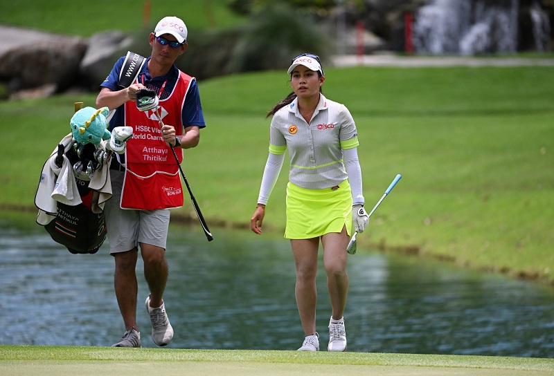 Atthaya Thitikul of Thailand and her caddie walk onto the fifteenth green during the Second Round of the HSBC Women's World Championship at Sentosa Golf Club on March 04, 2022 in Singapore. (Photo by Ross Kinnaird/Getty Images)