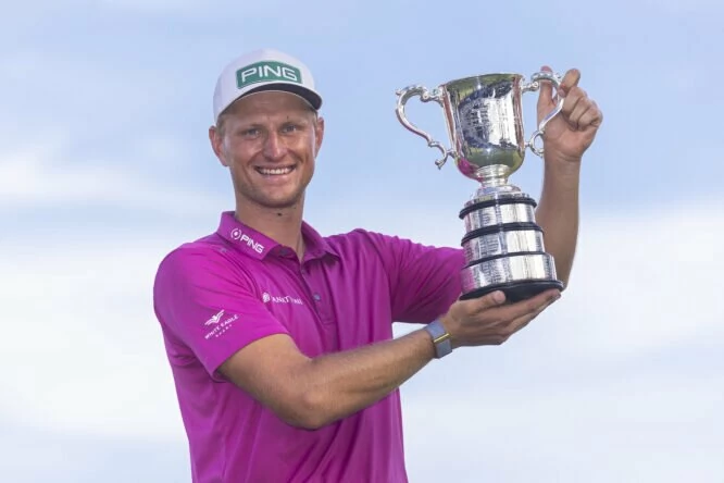 Adrian Meronk of Poland holds the trophy after winning the 2022 ISPS HANDA Australian Open at Victoria Golf Club on December 04, 2022 in Melbourne, Australia. (Photo by Daniel Pockett/Getty Images)