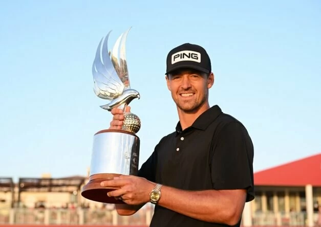 Victor Perez of France poses for a photo with the trophy after winning the final round of the Abu Dhabi HSBC Championship at Yas Links Golf Course on January 22, 2023 in Abu Dhabi, United Arab Emirates. (Photo by Ross Kinnaird/Getty Images)