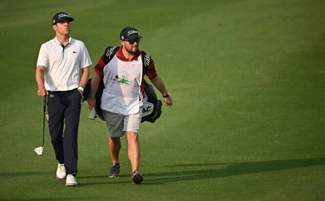 Yannik Paul of Germany walks with his caddie during Day Three of the Hero Indian Open at Dlf Golf and Country Club on February 25, 2023 in India. (Photo by Stuart Franklin/Getty Images)
