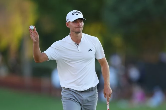 Nicolai Hojgaard of Denmark acknowledges the crowd on the 18th green during Day Two of the DP World Tour Championship on the Earth Course at Jumeirah Golf Estates on November 17, 2023 in Dubai, United Arab Emirates. (Photo by Andrew Redington/Getty Images) Nicolai Hojgaard of Denmark acknowledges the crowd on the 18th green during Day Two of the DP World Tour Championship on the Earth Course at Jumeirah Golf Estates on November 17, 2023 in Dubai, United Arab Emirates. (Photo by Andrew Redington/Getty Images)