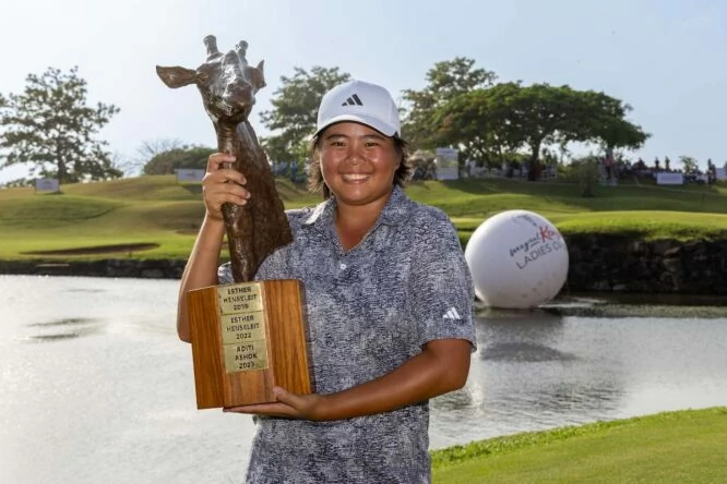 Shannon Tan holds the trophy in Kenya.