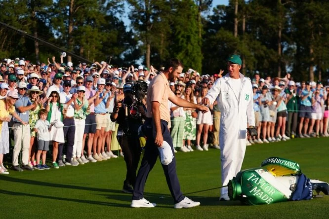 Scottie Scheffler and his caddy on the 18th green at Augusta National after his victory at the Masters of Augusta 2024. © Golffile | Fran Caffrey