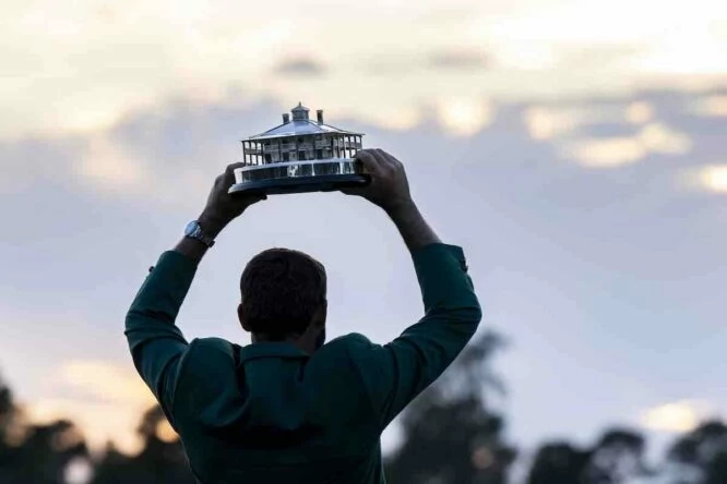 Scottie Scheffler posa con el trofeo de campeón del Masters en el green del hoyo 18.